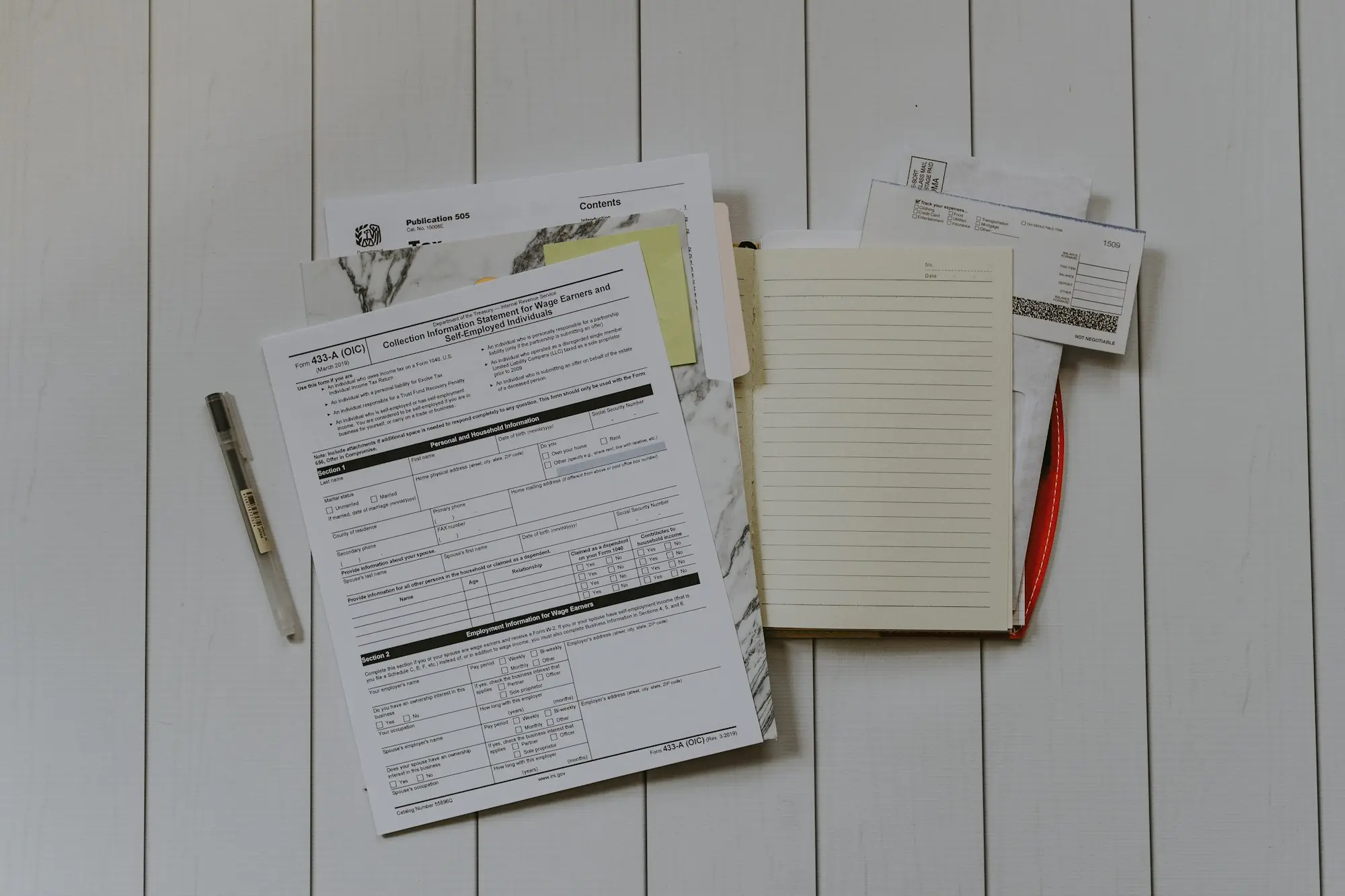 Builder's unpaid invoices and paperwork on a table