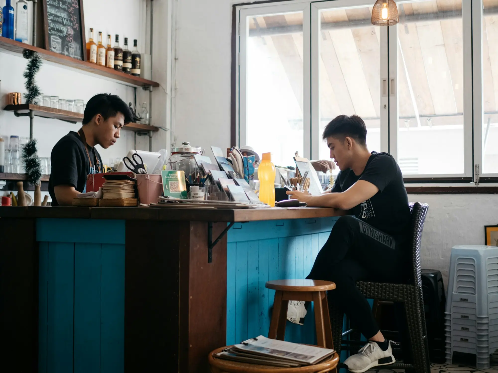 Cafe owner working on payroll on a laptop inside his Melbourne cafe