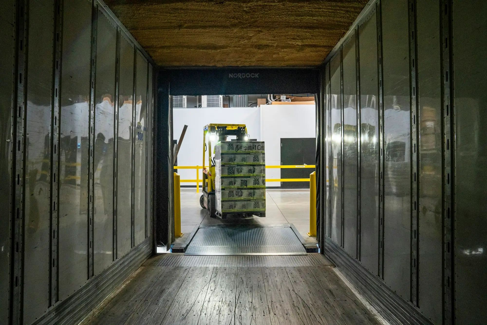 Supplier delivery pallets inside a shipping container at a warehouse